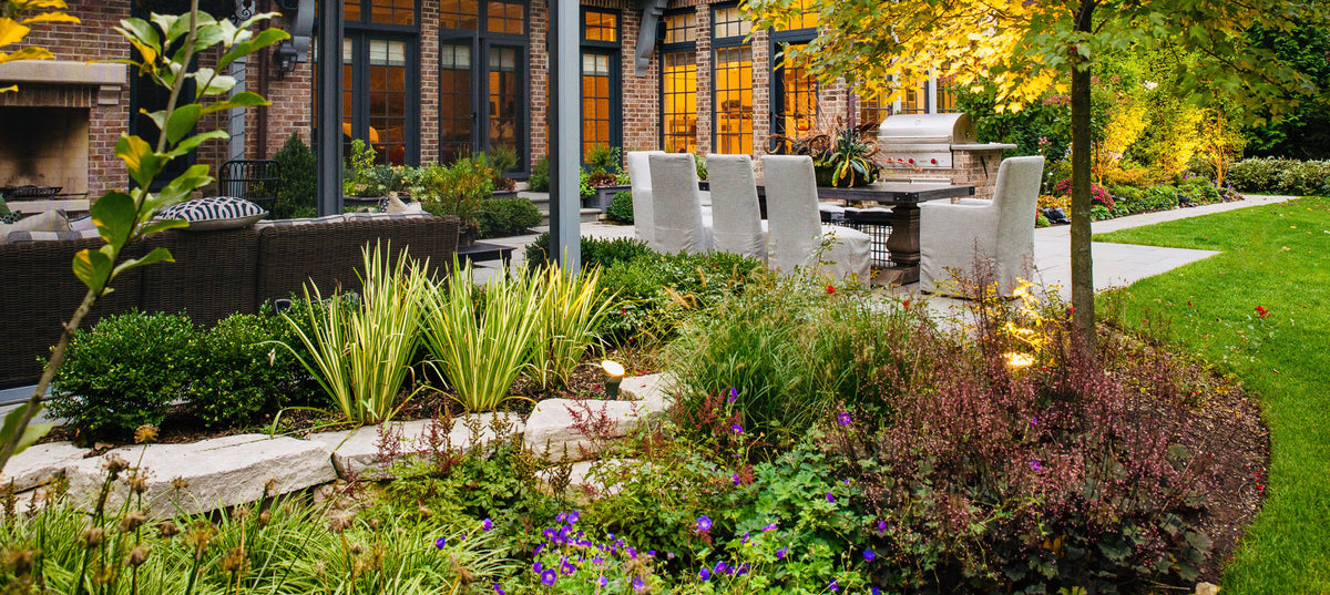 An early fall north shore landscape with outdoor kitchen, dining, and living area